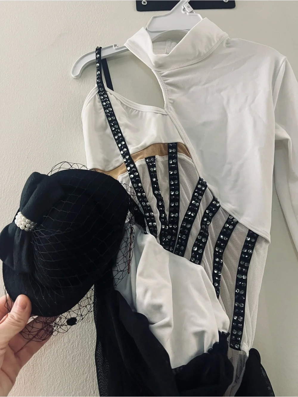 White and Black Asymmetric Dance leotard with Mesh Draping and cap.